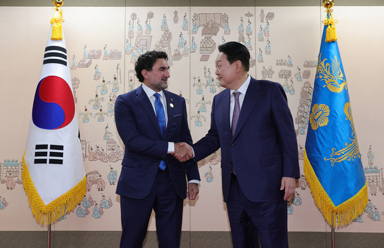 Yasir O. Al-Rumayyan, left, the governor of Saudi Arabia's sovereign wealth fund and the board chairman of state-run Aramco, shakes hand with President Yoon Suk Yeol at the presidential office on May 11, 2022, during Al-Rumayyan's previous visit to Korea to celebrate the president's inauguration. [JOINT PRESS CORP]
