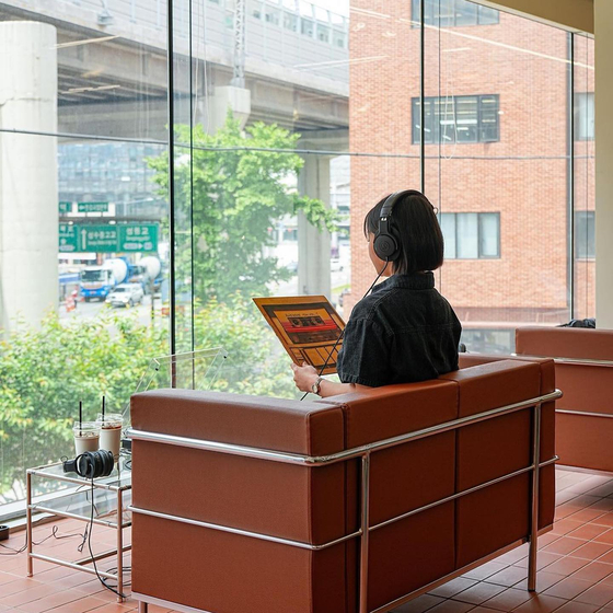 A visitor listens to an LP record at Vinyl Seongsu in Seongdong District, eastern Seoul. [VINYL SEONGSU]