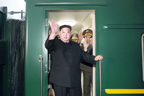 North Korean leader Kim Jong-un waves before departing on his armored train to head to Russia Sunday for a summit with Russian President Vladimir Putin, as seen in a photo released by the state-run Rodong Sinmun on Tuesday. [YONHAP] 
