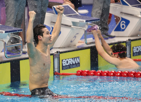 Korea's Hwang Sun-woo celebrates after finishing the men’s 4x200-meter freestyle relay at the Hangzhou Asian Games in first place at Hangzhou Olympic Sports Centre Aquatic Sports Arena in Hangzhou, China on Monday. [YONHAP]
