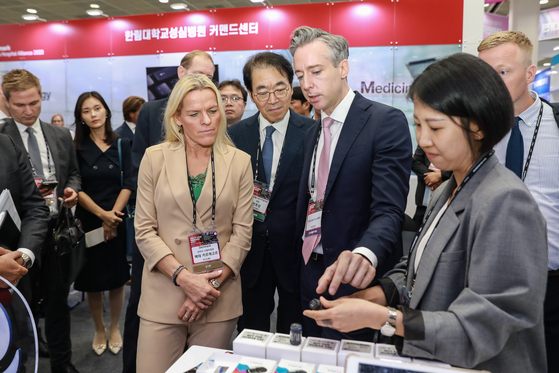 Novo Nordisk Korea General Manager Sasha Semienchuk, right, explains about the Mallya Smart Sensor to Danish Minister for Senior Citizens Mette Kierkgaard, at the Korea Digital Future Innovation Exhibition 2023 held at COEX in southern Seoul, Monday. [NOVO NORDISK PHARMA KOREA] 