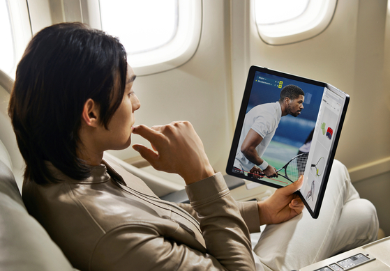 An LG Gram Fold laptop is held horizontally. [LG ELECTRONICS]