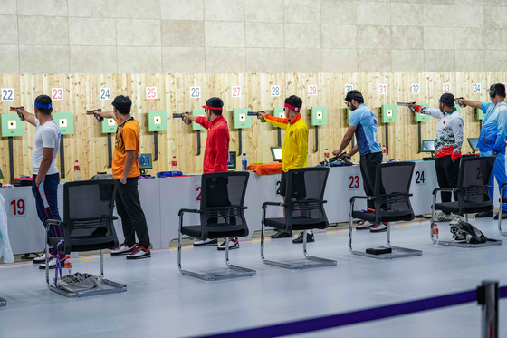 Athletes compete in the men's team 10-meter air pistol contest at the Hangzhou Asian Games held at Fuyang Yinhu Sports Center in Hangzhou, China on Thursday. [XINHUA] 