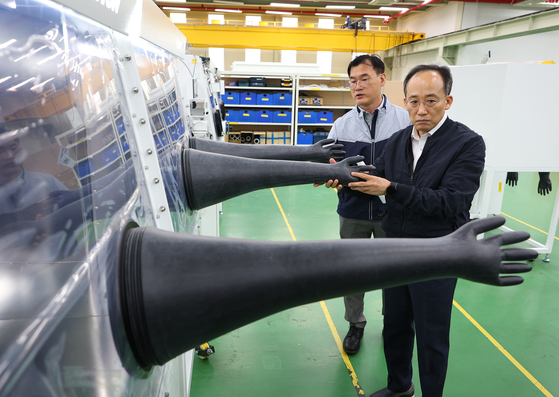 Finance Minister Choo Kyung-ho, front, tours Koreakiyon, a secondary battery research equipment manufacturing firm, in southern Seoul on Oct. 3, 2023. 