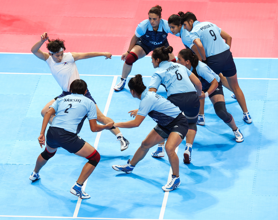 Korea's Jo Hyun-ah, wearing white, competes during a women's Group A game against India at the 19th Asian Games in Hangzhou, China on Tuesday. [XINHUA]