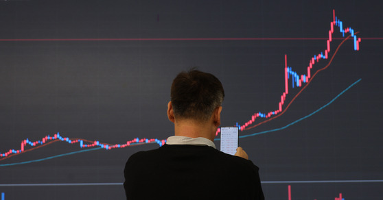 Market conditions for Bitcoin are displayed on a screen at the Bithumb headquarters, located in Gangnam, southern Seoul, on Tuesday. Bitcoin prices have climbed to a two-and-a-half-year high, peaking at over $35,100 in Tuesday's early trading session, and is now being traded at over $30,000. [YONHAP]