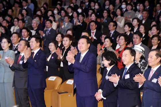 President Yoon Suk Yeol, center, claps at the 58th National Convention of Women at COEX convention center in Gangnam, southern Seoul, Wednesday. [JOINT PRESS CORPS] 