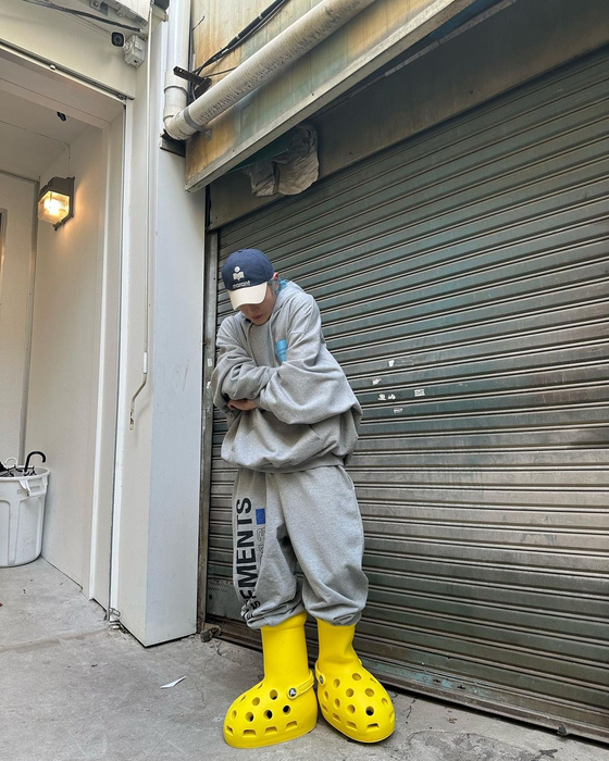 Taeyong of NCT sports the yellow Crocs-inspired version of MSCHF's big cartoon boots. [SCREEN CAPTURE]