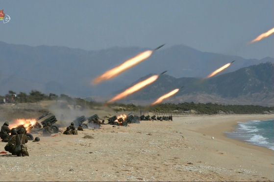 In this footage broadcast by Pyongyang's state-controlled Korean Central Television in March 2020, the North Korean military conducts a live artillery firing exercise. [YONHAP]
