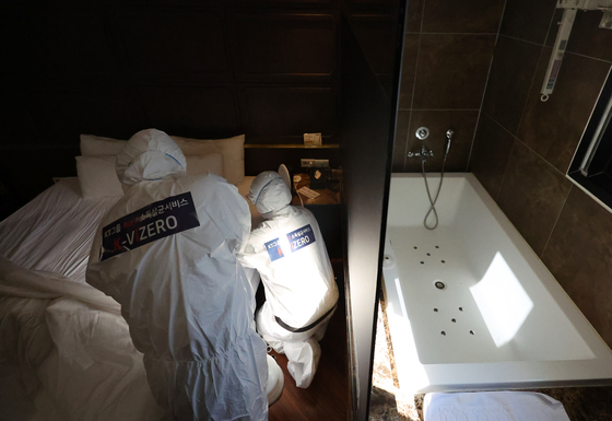 Professional cleaners inspect and sterilize the accommodation facility in Busan on Monday. [YONHAP] 