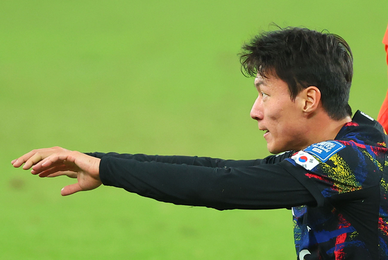Korea's Hwang Ui-jo stands up on the field after falling over a Chinese defensive foul during the match against China in Shenzhen, China on Tuesday. [YONHAP]