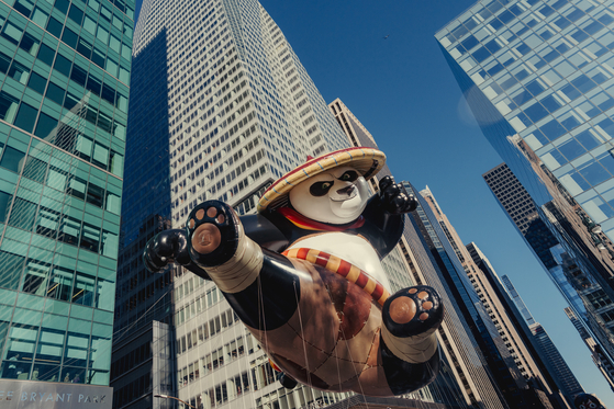 Parade balloons are guided along the route during the Macy’s Thanksgiving Day Parade in New York, Thursday, Nov. 23, 2023. In the days leading up to the parade, organizers test the giant balloons to help ensure safety. [Amir Hamja/The New York Times]