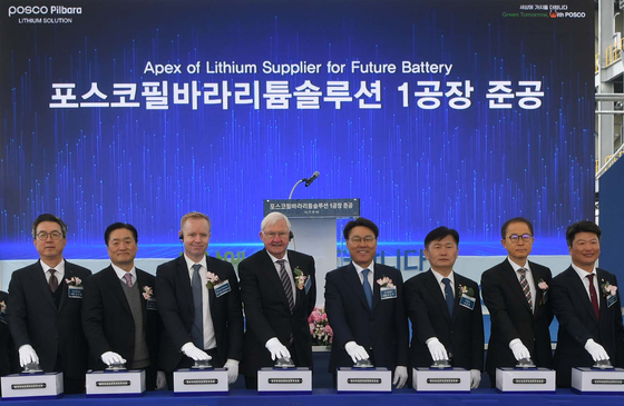 Executives and officials from Posco Group, Pilbara Minerals and the Korean government including Posco Holdings Chairman Choi Jeong-woo, fifth from left, take a photo at a ceremony celebrating the company's completion of a lithium hydroxide factory in South Jeolla on Wednesday. [POSCO HOLDINGS]