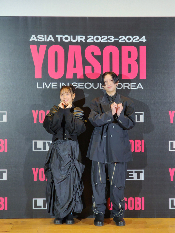 Japanese project group Yoasobi poses for the camera during a press conference held Monday in central Seoul. [LIVET]