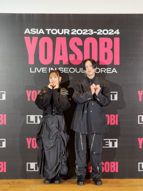 Japanese project group Yoasobi poses for the camera during a press conference held Monday in central Seoul. [LIVET]