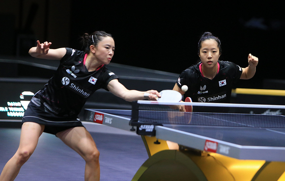 Korean table tennis prodigy Shin Yu-bin, right, and Jeon Ji-hee compete in the women's doubles qualifiers at the WTT Contender Doha 2023 in Doha, Qatar on Tuesday. Shin advanced in both the women's doubles and the mixed doubles, in which she competed with Lim Jong-hoon, at the tournament.  [YONHAP]