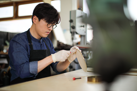 Designer Kwon Jung-mo works in his studio in Seodaemun District, western Seoul. [KWON JUNG-MO]