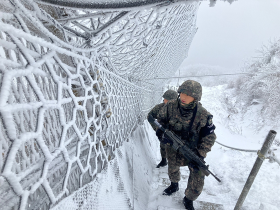Soldiers of the 21st Infantry Division patrol the barbed wire fence along Mount Gachilbong in Yanggu County, Gangwon, on Dec. 12, 2023. [YONHAP]