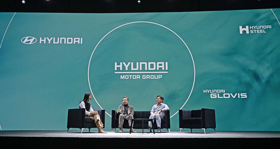 Hyundai Motor CEO Jay Chang, center, and Kim Chang-hwan, right, head of hydrogen fuel cell and battery development, talk during a presentation at Mandalay Bay in Las Vegas ahead of CES 2024, which kicks off on Tuesday. [HYUNDAI MOTOR]