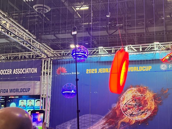 A drone soccer match, using rules and technology developed in Jeonju, North Jeolla, is demonstrated at CES 2024 in Las Vegas on Tuesday. In drone soccer, two teams of five compete in three sets, each three minutes long. Each player maneuvers their own drone, which is enclosed in a ball-shaped case. Players control the drone-balls to score and defend against the opposing team. [YONHAP]
