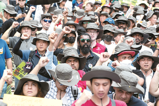 Foreign workers hold a protest outside Yongsan Station in central Seoul on Aug. 20, 2023, demanding better treatment for non-Korean laborers. [NEWS1]