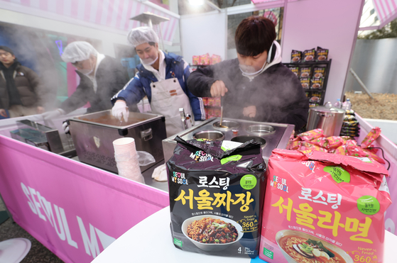 Workers cook Seoul Ramyun and Seoul Jjajang at the Seoul city government's first pop-up store in Seongdong District, eastern Seoul, on Thursday. The store, located in a cafe called Sennue, will be open from Friday to Sunday. Visitors will be able to purchase Seoul-related merchandise including accessories, stationery and food. [YONHAP]