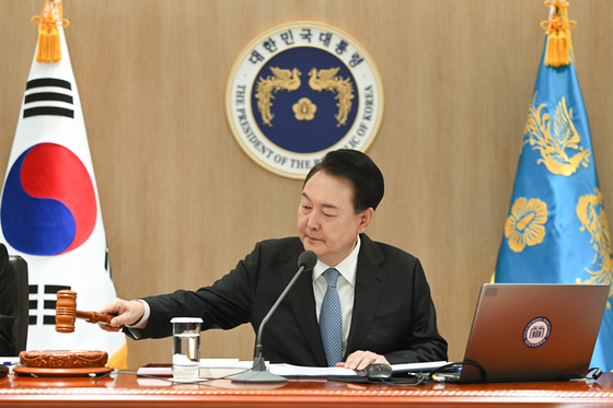 President Yoon Suk Yeol presides over a Cabinet meeting at the Yongsan presidential office in central Seoul on Tuesday. He granted special pardons to key political and business figures ahead of the Lunar New Year holiday. [JOINT PRESS CORPS]
