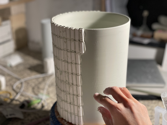 Jin Hye-rin presses small, rectangular stamps onto the surface of her ceramics. [JIN HYE-RIN]