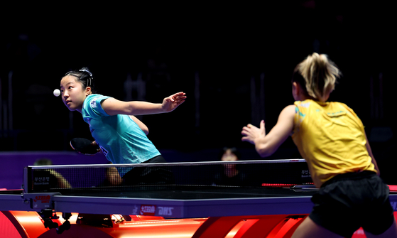 Korea's Shin Yu-bin, left, serves the ball during a World Team Table Tennis Championships women's team match against Brazil at BEXCO Convention Centre in Busan on Wednesday. [YONHAP] 