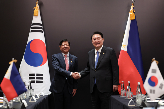 President Ferdinand Marcos Jr. of the Phillippines, left, and President Yoon Suk Yeol shake hands during a summit on the sidelines of the 43rd Asean Summit in Jakarta, Indonesia on Sept. 7, 2023. [PRESIDENTIAL OFFICE]