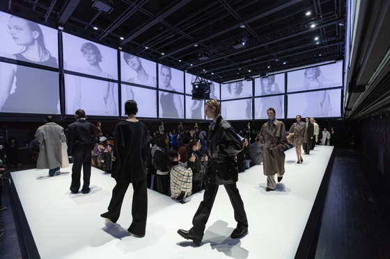 Models showcase clothes from Korean designer brands System and System Homme for the 2024 Fall/Winter Collection at Paris's La Gaîté Lyrique on Jan. 21. [HYUNDAI DEPARTMENT STORE] 