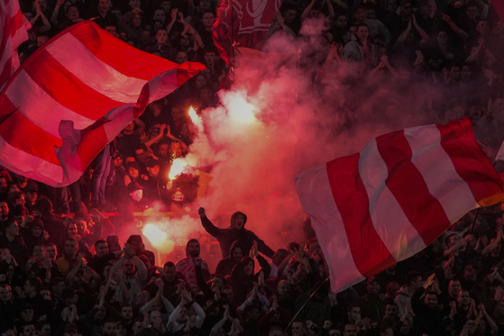 Red Star fans light fireworks during a match against Partizan in Belgrade, Serbia on Saturday.  [AP/YONHAP]