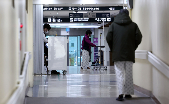 Patients move along the corridors of the National Medical Center in Jung District, central Seoul, on Sunday, the 20th day of the ongoing walkout by junior doctors from major hospitals across the country. [YONHAP]