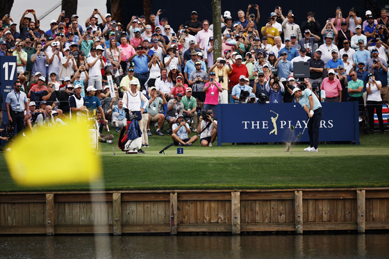 Scottie Scheffler of the United States plays his shot from the 17th tee during the final round of The Players Championship on The Players Stadium Course at TPC Sawgrass in March 2023 in Ponte Vedra Beach, Florida. [GETTY IMAGES]