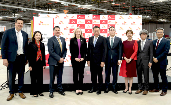 Cho Jae-yeon, fourth from right, head of SK ecoplant's environment business unit, Terrance Ng, fifth from right, CEO of SK tes, and other executives and officials from the Virginia state government take a photo at an opening ceremony of SK ecoplant's hyperscale IT Asset Disposition (ITAD) factory in Fredericksburg, Virginia, on March 13. [SK ECOPLANT] 