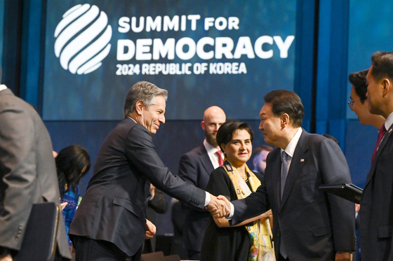 President Yoon Suk Yeol, right, shakes hands with U.S. Secretary of State Antony Blinken during the opening ceremony of the third Summit for Democracy held at The Shilla Seoul in Jung District, central Seoul, on Monday. [PRESIDENTIAL OFFICE]