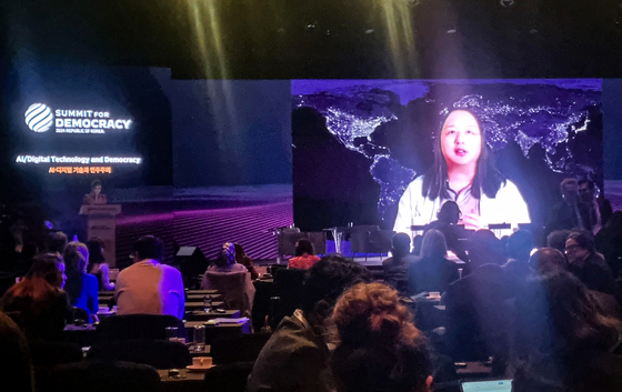 Taiwanese Minister of Digital Affairs Audrey Tang speaks via a video recording during a roundtable session of the third Summit for Democracy held at The Shilla Seoul in Jung District, central Seoul, on Monday. [YONHAP]