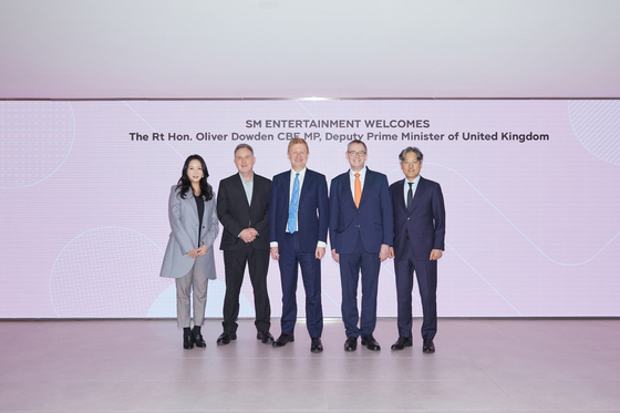 SM Entertainment executives and British envoys pose for a photo at SM Entertainment's headquarters in Seongsu-dong, eastern Seoul on Tuesday. From left are SM Entertainment CGO Mina Choi, Director of the British Council in Korea Paul Clementson, U.K. Deputy Prime Minister Oliver Dowden, British Ambassador to Korea Colin Crooks and Jang Cheol-hyuk. [SM ENTERTAINMENT]