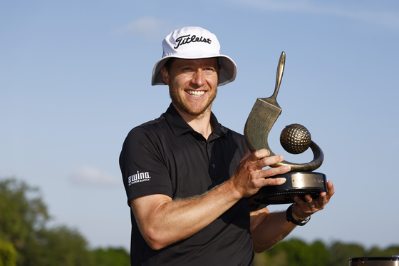 Peter Malnati poses with the Valspar Championship Trophy after the final round of the Valspar Championship at Copperhead Course at Innisbrook Resort and Golf Club in Palm Harbor, Florida on Sunday. [GETTY IMAGES]