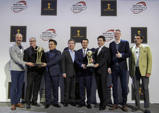 From left, Kia Executive Vice President Karim Habib, Genesis Chief Creative Officer Luc Donckerwolke Luc Donckerwolke, Kia North America CEO Yoon Seung-kyu, Hyundai Motor CEO Chang Jae-hoon, Hyundai Motor Global Chief Operating Officer Jose Munoz, Hyundai and Genesis Global Design Center Head Lee Sang-yup, Hyundai Motor Vice President and Head of N Brand Management and Motorsport Till Wartenberg and World Car Awards Chair Siddharth Vinayak Patankar pose for a photo with their trophies at the New York International Auto Show on Wednesday. [HYUNDAI MOTOR]