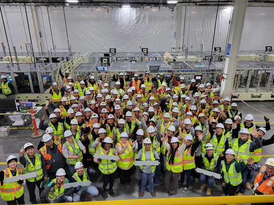 Ultium Cells workers take a photo with the first batch of EV batteries produced at its second plant in Spring Hill, Tennessee. [LG ENERGY SOLUTION] 