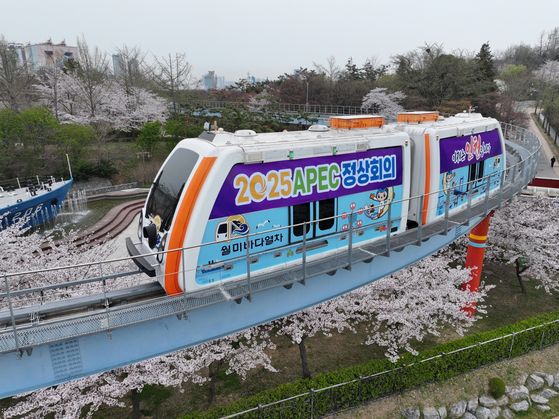 A Wolmi Sea Train monorail runs on a railway at the Wolmi Theme Park in Incheon on Monday, with a wrapping promoting the west coast city's bid to host the Asia-Pacific Economic Cooperation (APEC) summit in 2025. [JOINT PRESS CORPS]