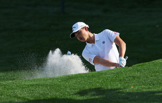 Min Woo Lee of Australia plays a shot on the 16th hole prior to The Players Championship on the Stadium Course at TPC Sawgrass on March 12 in Ponte Vedra Beach, Florida. [GETTY IMAGES]