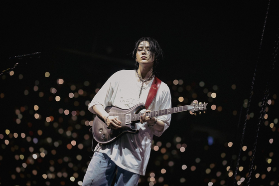 A scene from Suga’s concert film, “Suga | Agust D Tour ‘D-Day’ The Movie,” which documented the finale show of his “Suga Agust D Tour.” The tour captivated a total audience of 290,000 concertgoers over 25 concerts held in 10 cities. [HYBE, TRAFALGAR RELEASING]