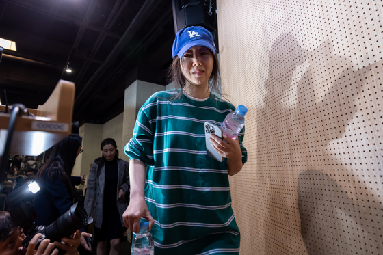 ADOR CEO Min Hee-jin walks in for her press conference held in Seocho District, southern Seoul, on Thursday. [YONHAP]