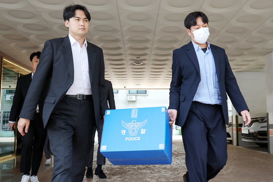 Police investigators moves confiscated items after conducting a search and seizure at the Korean Pediatric Association office, in Mapo District, western Seoul, on Friday. [NEWS1] 