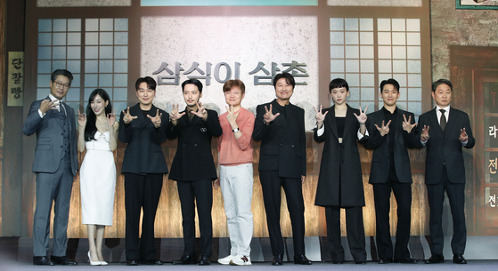 The cast and showrunner of Disney+ original series ″Uncle Samsik″ pose for cameras during a press conference at the Grand InterContinental Seoul Parnas hotel in Gangnam District, southern Seoul, on Tuesday. From left are Yoo Jae-myung, Tiffany Young, Seo Hyun-woo, Byun Yo-han, Shin Yeon-shick, Song Kang-ho, Jin Ki-joo, Oh Seung-hoon and Joo Jin-mo. [NEWS1]