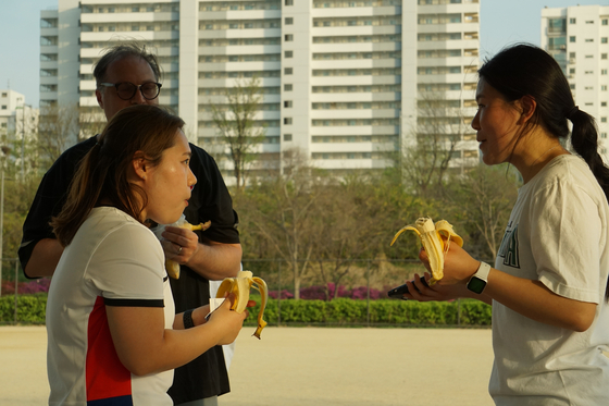 Mary, right, is elated to have in hand a banana.