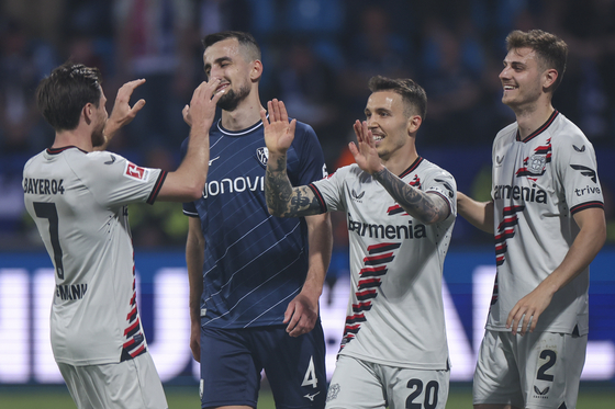 Bayer 04 Leverkusen, in white, celebrate during a Bundesliga match against VfL Bochum in Bochum, Germany on Sunday. [EPA/YONHAP]  