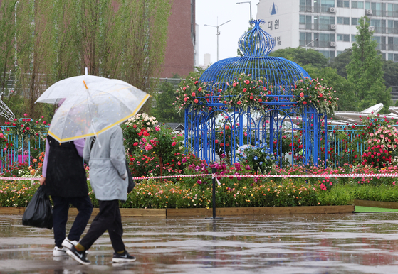 People walking by a garden created by domestic and foreign experts and citizens at Ttukseom Hangang Park in Seoul on Wednesday. [YONHAP]  